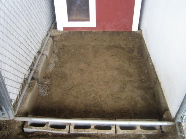 The first thing we do is dig out the kennel 12 inches deep (10 wheelbarrow loads).  Then we line the perimeter of the kennel with 8 inch tall cinder blocks to prevent dogs from digging out of the kennel.