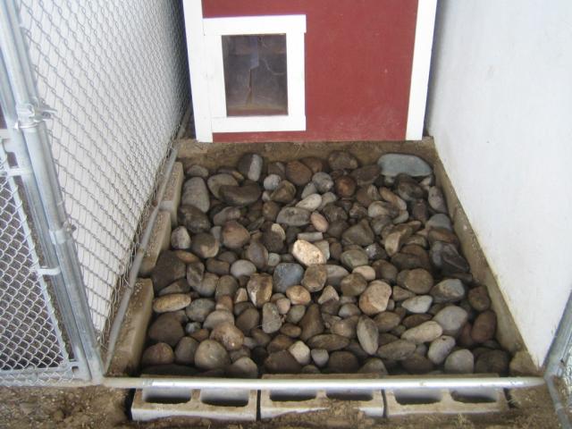 The last 2 loads of river rock are large rocks.  This discourages dogs from digging.  If they're able to dig down to this level they'll hit large river rock and will immediately lose interest.